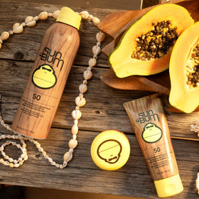 Application du spray solaire Sun Bum SPF 50 sur la peau