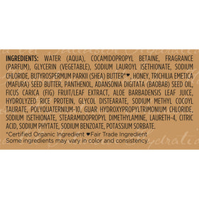 Bouteille de Shampooing Shea Moisture entourée d'huiles