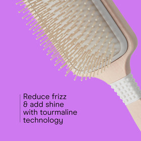Brosse à cheveux Conair sur un fond neutre, vue de côté