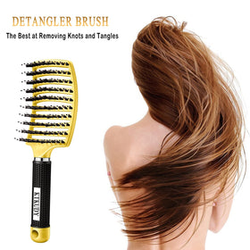 Brosse KTKUDY posée sur une surface avec cheveux démêlés à côté