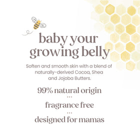 Burt's Bees Mama Belly Butter 240g sur une table avec des fleurs