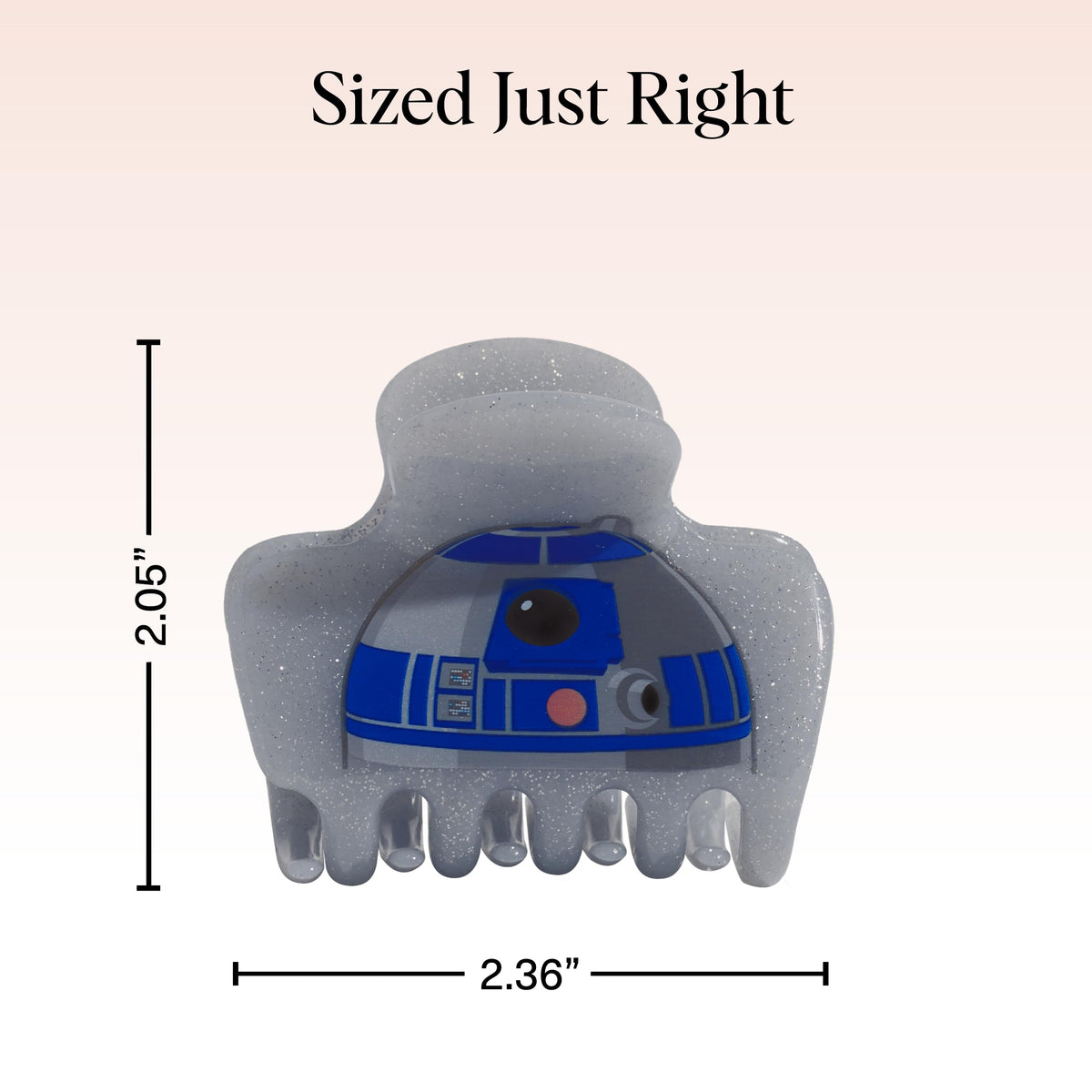 Clip à cheveux Kitsch R2-D2 sur un bureau