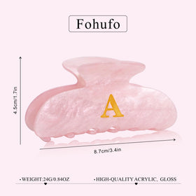 Clip cheveux Fohufo Lettre J sur un fond neutre