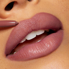 Crayon à Lèvres Repulpant ColourPop sur une table de maquillage