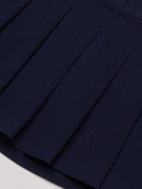 Détail de la jupe plissée avec zip caché et taille élastique
