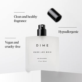 DIME Dans Les Bois Eau de Toilette sur une table en bois