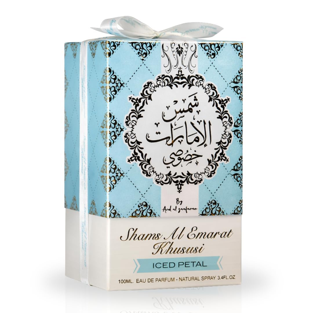 Eau de Parfum Shams Al Emarat 100ml sur une table avec des fleurs