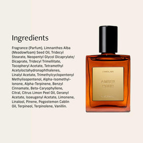 Flacon d'huile de parfum CYKLAR Ambre Heure 15ml près d'un bouquet de fleurs