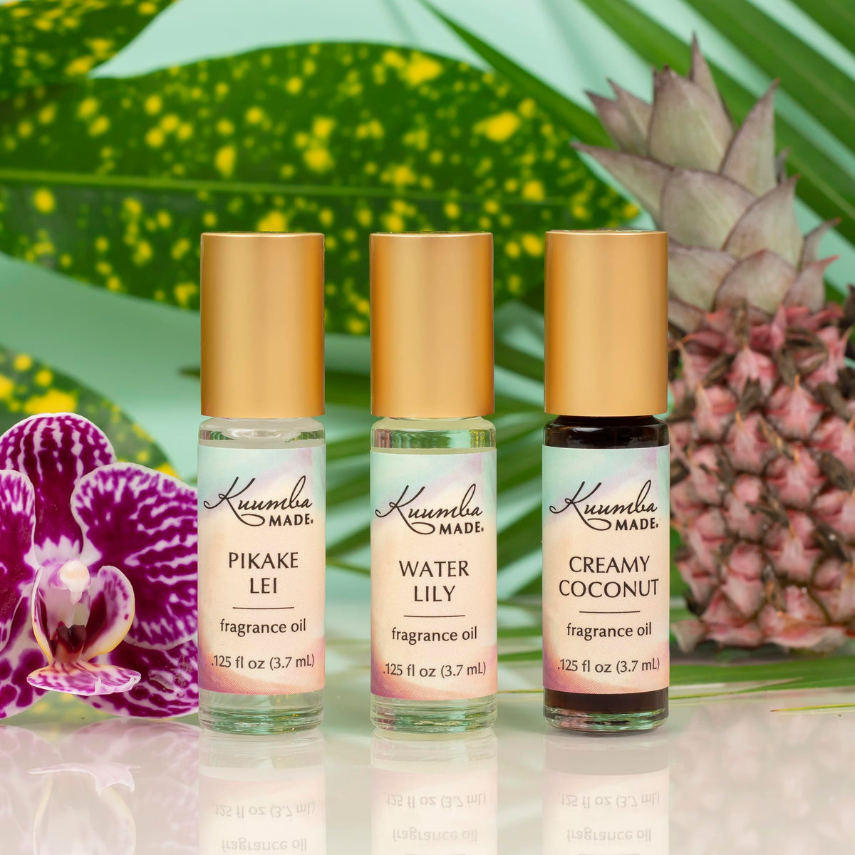 Flacon de l'huile parfumée Coco Crémeux Kuumba Made sur fond floral
