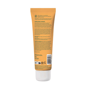 Lotion corps ATTITUDE sur une table avec des fleurs d'oranger
