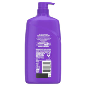Shampooing Aussie Miracle Curls avec fruits et fleurs en arrière-plan