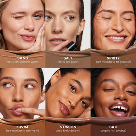 Stick bronzant Saie Dew Bronze à côté de produits de beauté