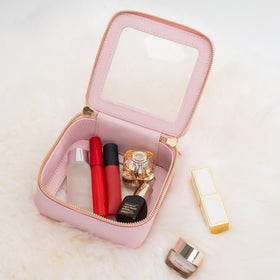 Trousse de maquillage Aveniee rose à côté d'autres accessoires de beauté