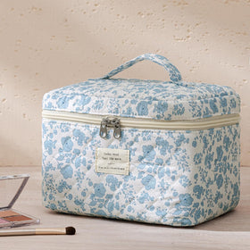 Trousse de maquillage HBselect en coton avec motif floral sur une surface blanche